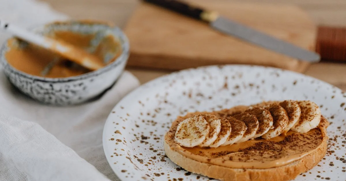 Délicieuse tartine garnie de beurre de cacahuète, de tranches de banane et de cacao, parfaite pour une collation saine.